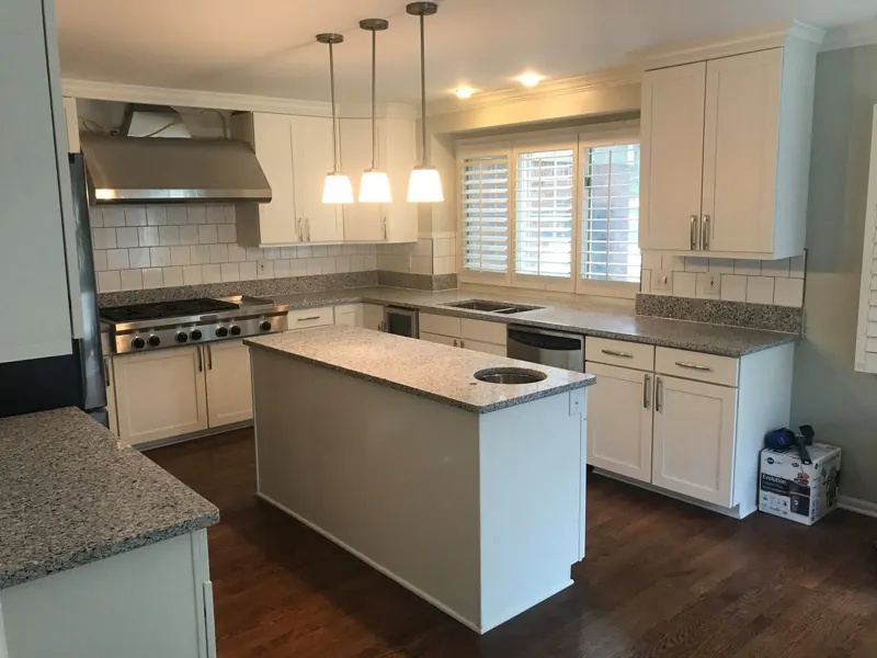 White kitchen with granite perimeter counters and a professional range